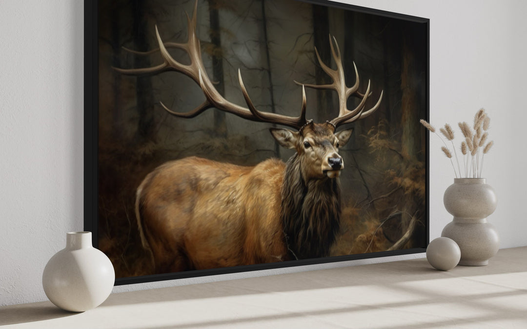 Framed canvas wall art of a majestic elk with large antlers in a dark, dense forest setting.