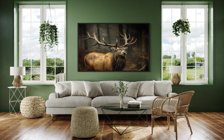 Elk with big antlers in a forest framed canvas wall art hanging above a sofa in a green room.