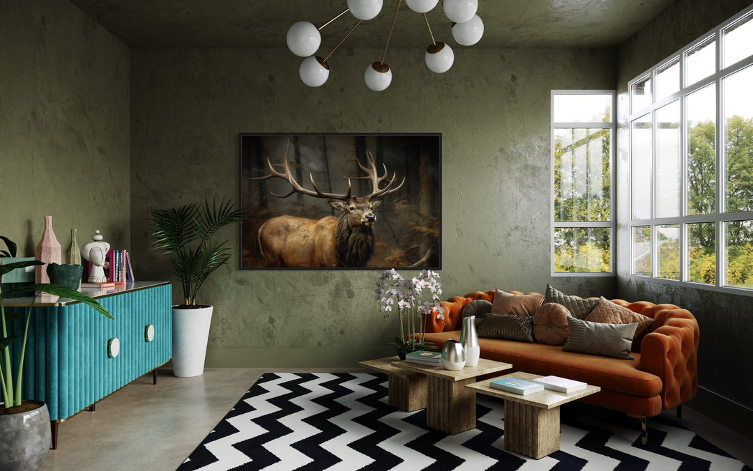 Elk with big antlers in a forest framed canvas wall art hanging in a modern living room.