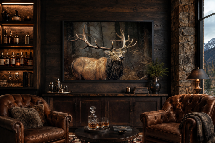 Elk with big antlers in a forest framed canvas wall art hanging in a rustic living room.
