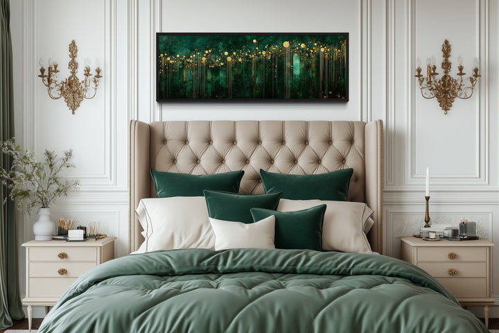 Horizontal art deco framed canvas with emerald green and gold patterns above a tufted headboard.