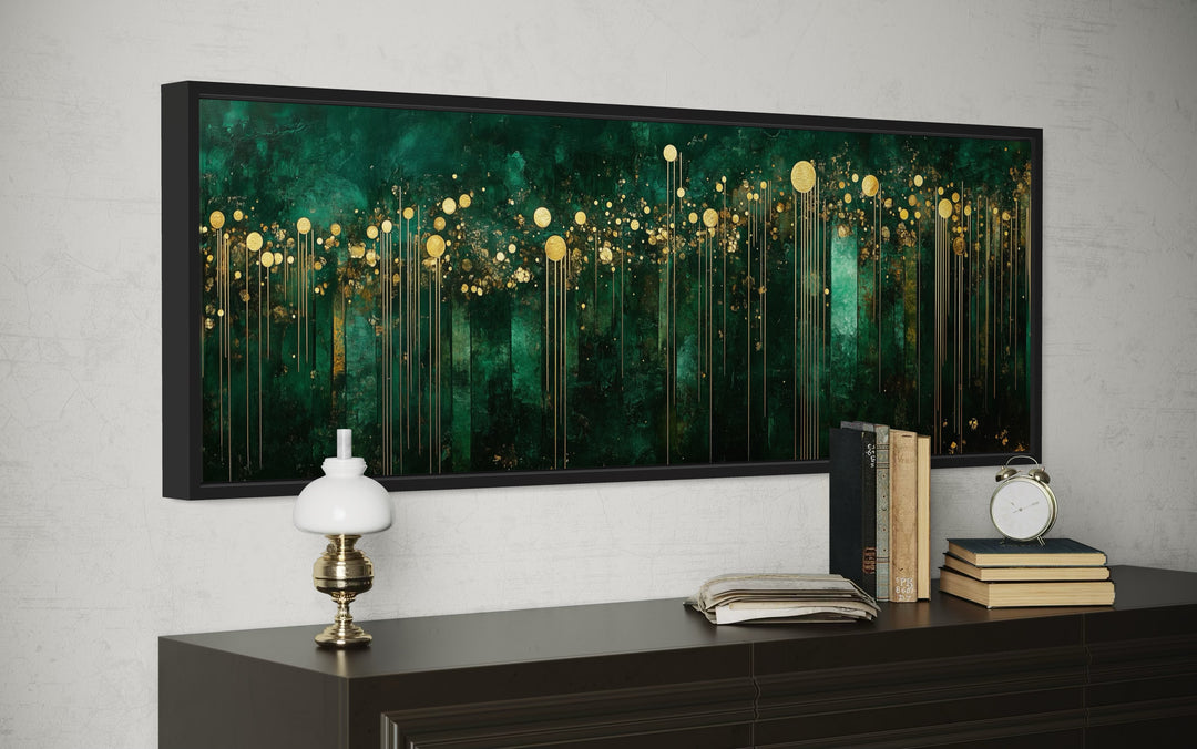 Horizontal emerald green and gold art deco framed canvas wall art above a dark wood dresser.