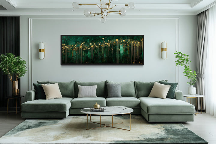 Emerald green and gold horizontal art deco framed canvas wall art hanging above a green sofa.