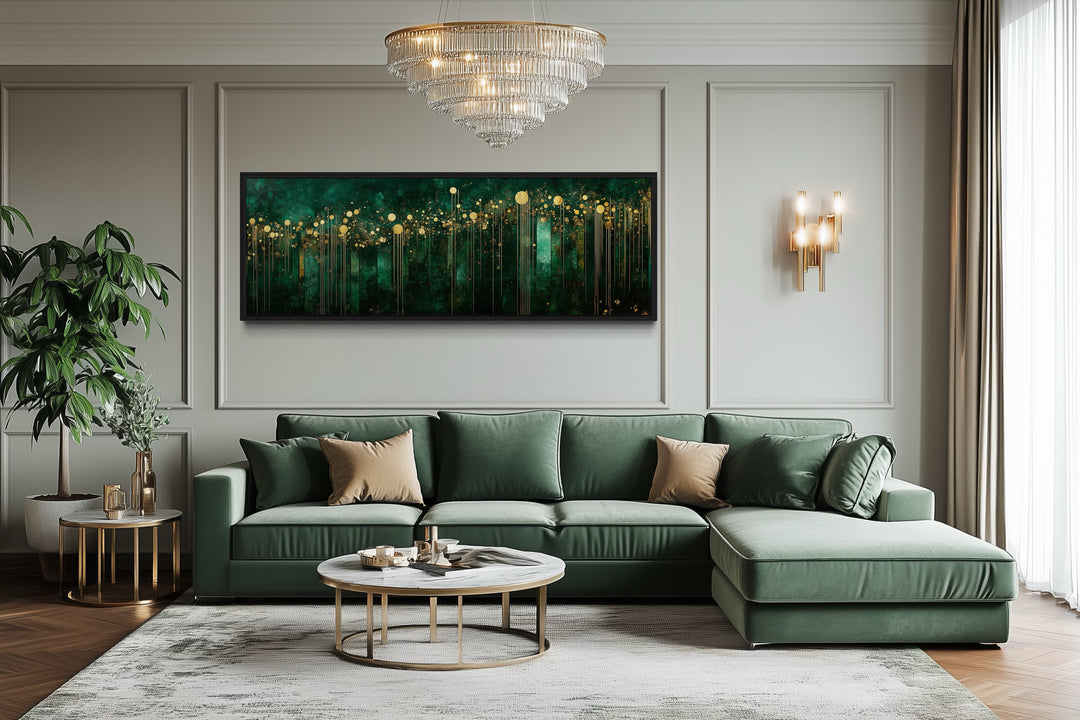 Horizontal art deco framed canvas with emerald green and gold patterns above a green sofa.