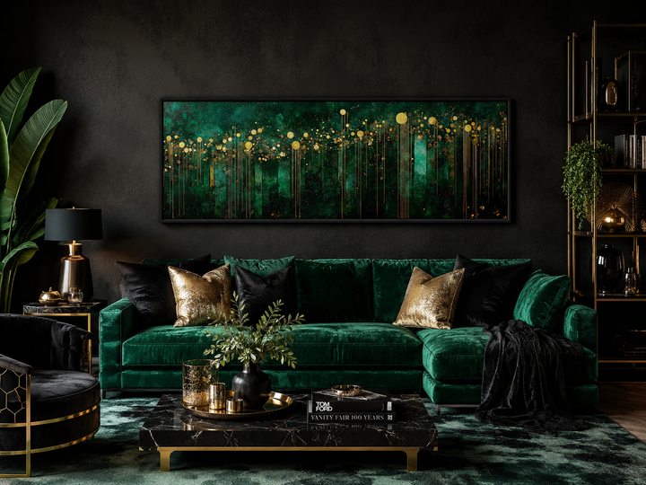 Emerald green and gold art deco horizontal framed canvas wall art above a green velvet sofa.