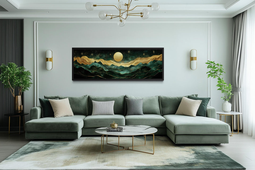 Emerald green and gold panoramic mountain landscape wall art centered above a modern green sofa.