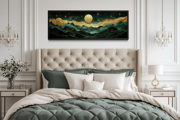 Emerald green and gold panoramic mountain landscape wall art hanging above a tufted headboard.