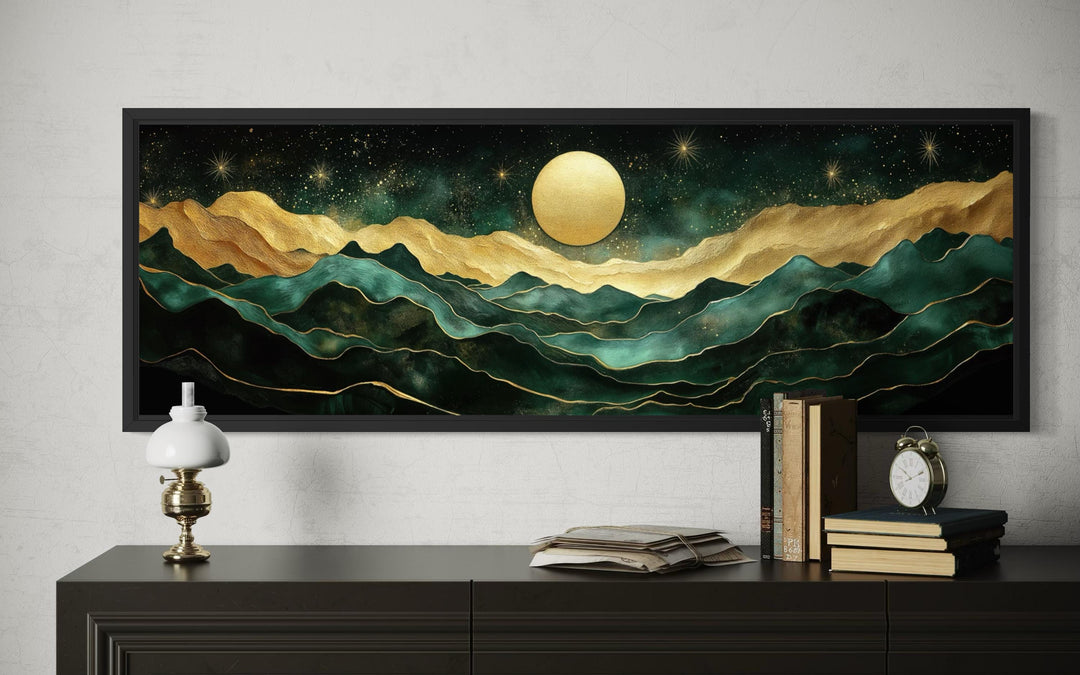 Panoramic emerald green and gold mountain landscape wall art with a moon in a black frame.