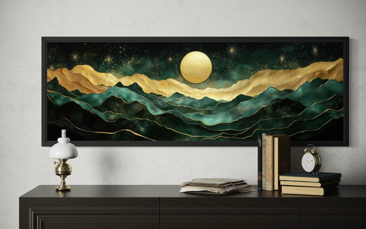 Panoramic emerald green and gold mountain landscape wall art with a moon in a black frame.
