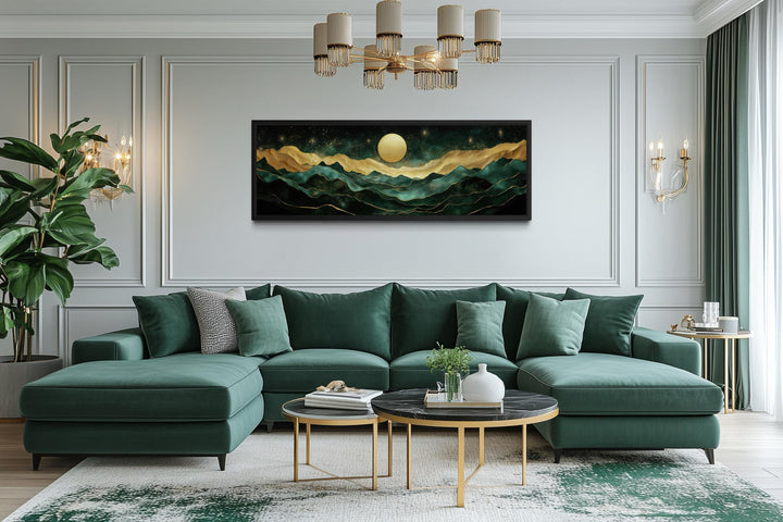 Emerald green and gold panoramic mountain landscape wall art centered above a modern green sofa.