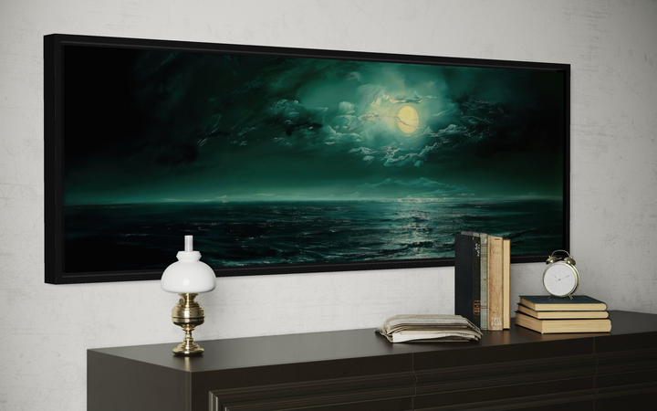 Emerald green ocean seascape wall art with a full moon in a black frame above a dark wood dresser.