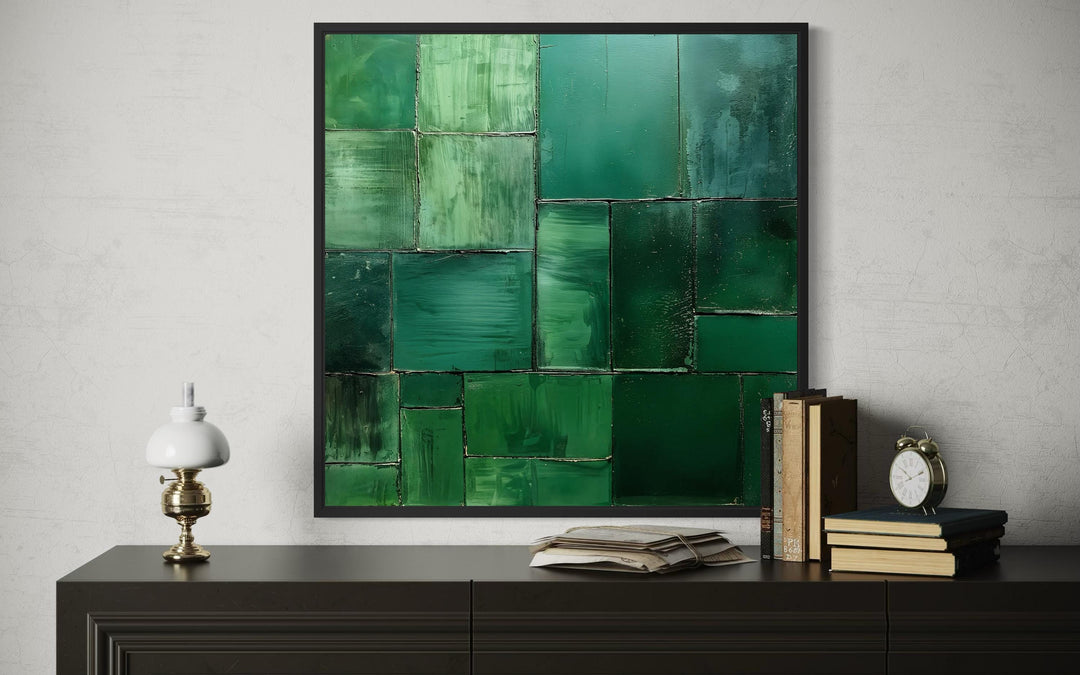 Emerald green modern geometric painting on a square canvas print in a black frame.