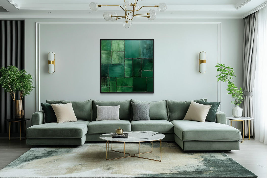 Modern geometric emerald green abstract painting on a square canvas print in a living room.
