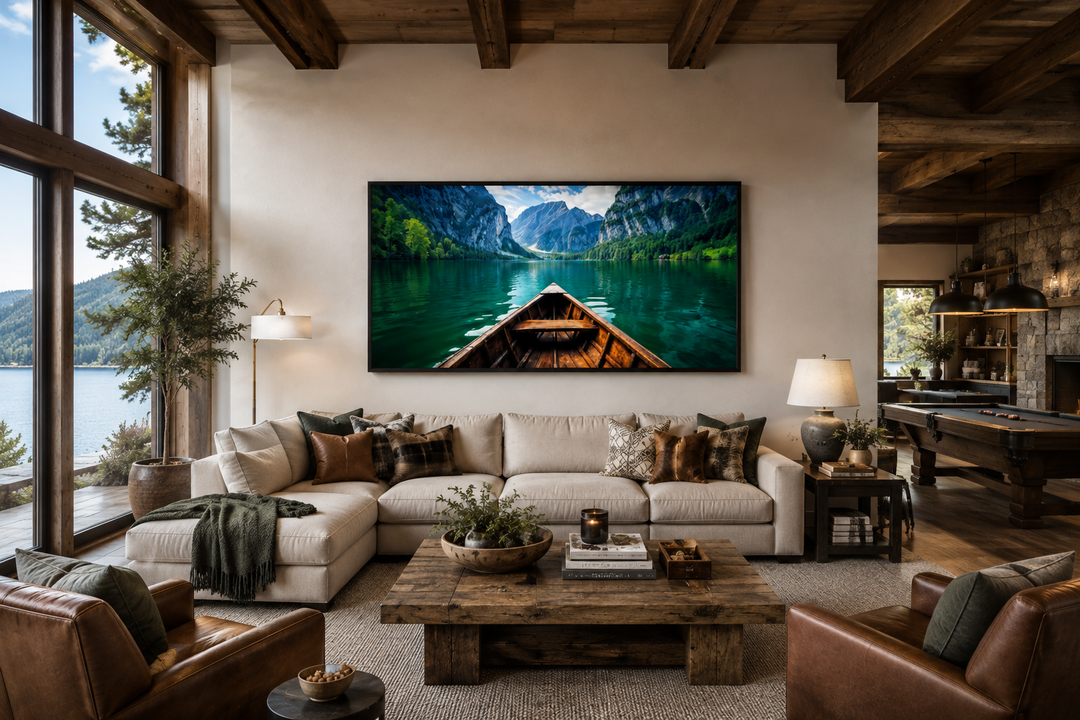 Framed wall art of a wooden boat on an emerald green lake in a rustic living room.