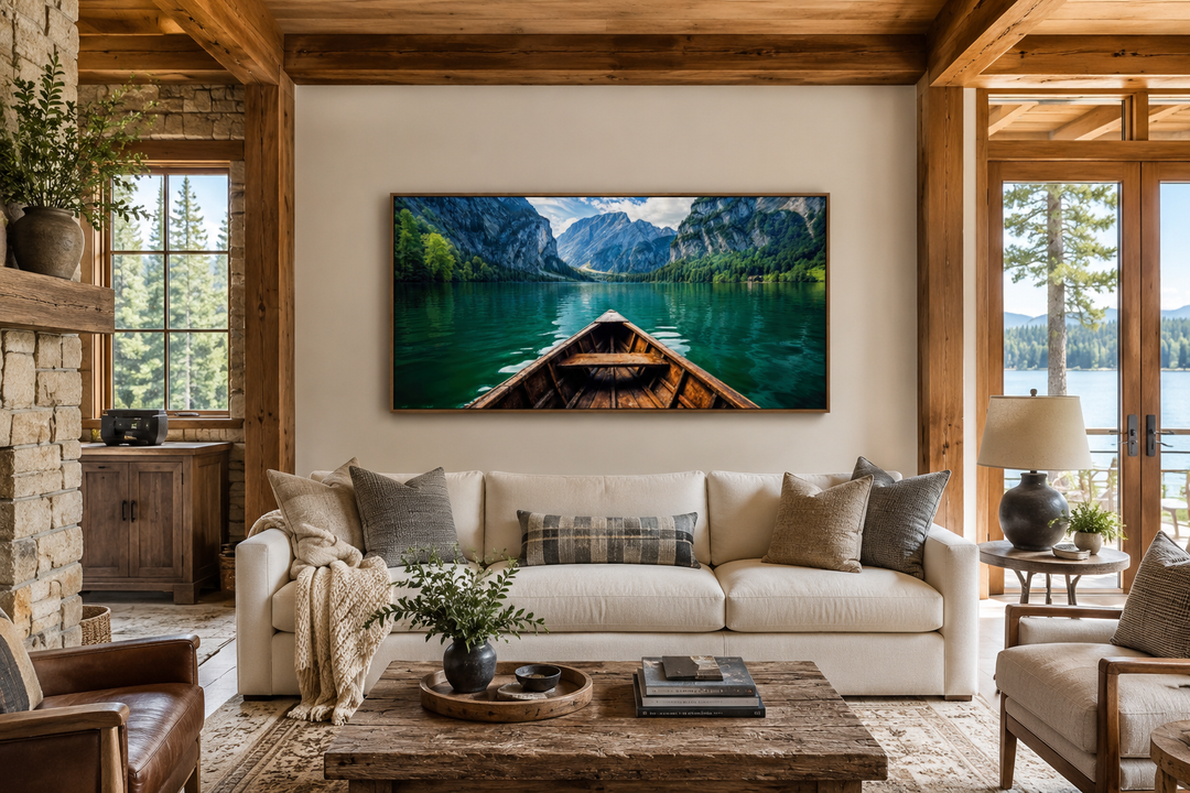 Framed wall art of a wooden boat on an emerald green lake, displayed above a white sofa.