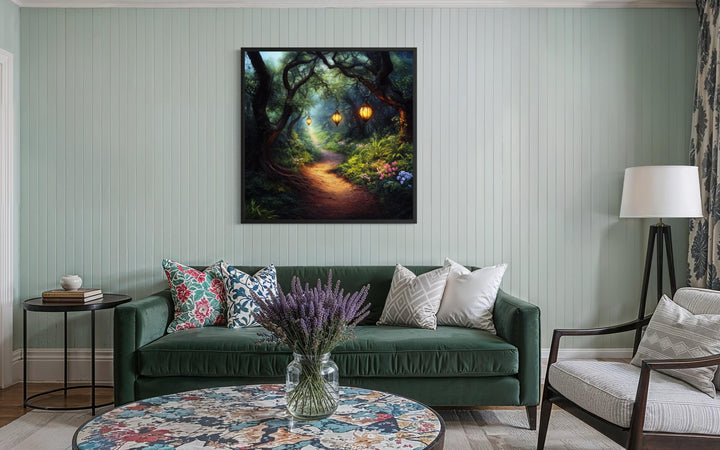 Enchanted forest wall art featuring a glowing lantern path in a framed canvas over a green sofa.