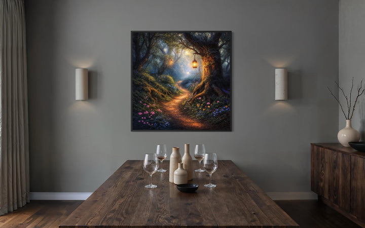 A framed canvas print of a magical woodland path with a glowing lantern hangs in a modern dining room.