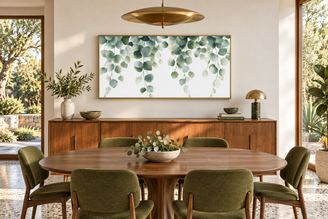 Horizontal framed canvas wall art featuring cascading sage green eucalyptus leaves on a white base.