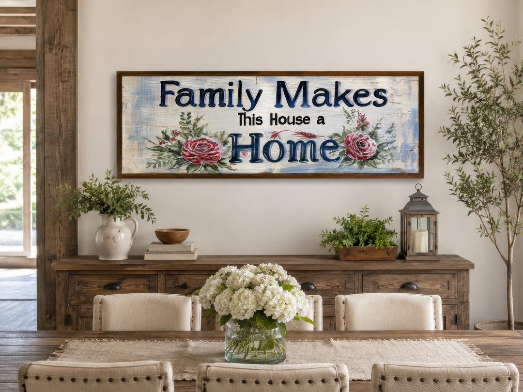 Framed horizontal canvas sign reading 'Family Makes This House a Home' with red floral accents.