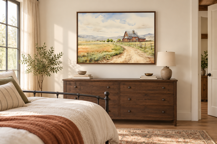 Old barn in a golden farm field vintage framed canvas wall art above a dark wood dresser.