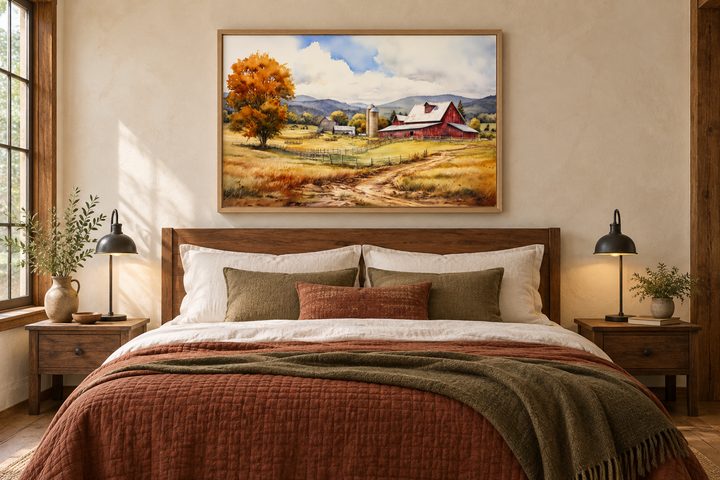 Framed canvas wall art of a red barn in a golden field hanging above a bed in a rustic bedroom.