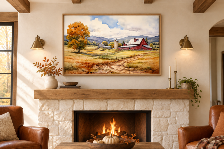Framed watercolor painting of a red barn in a field above a stone fireplace with a burning fire.