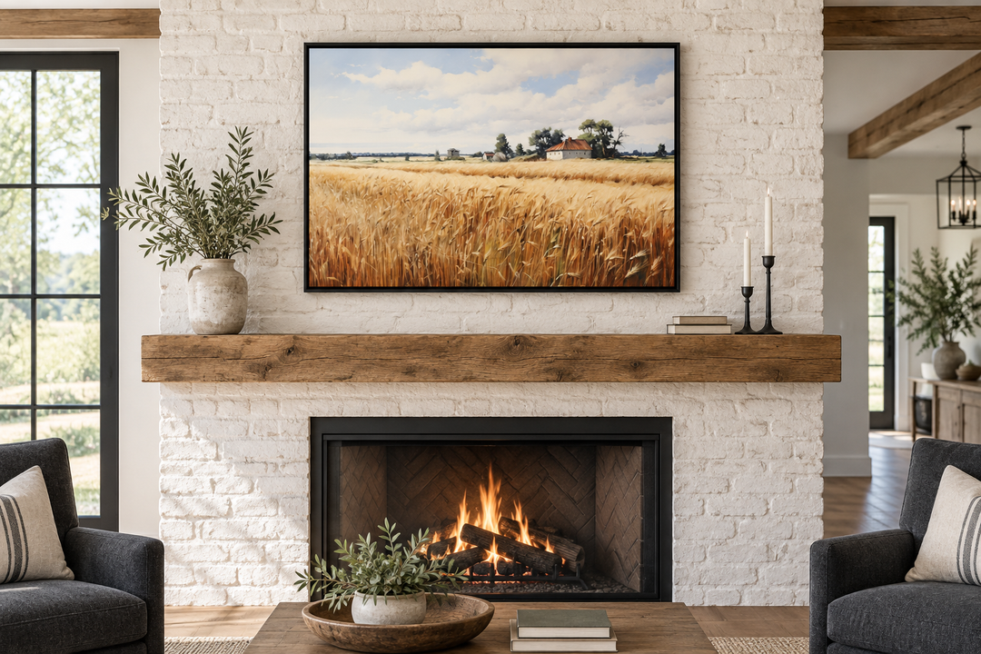 Rustic wheat field landscape framed canvas wall art hanging above a white brick fireplace.