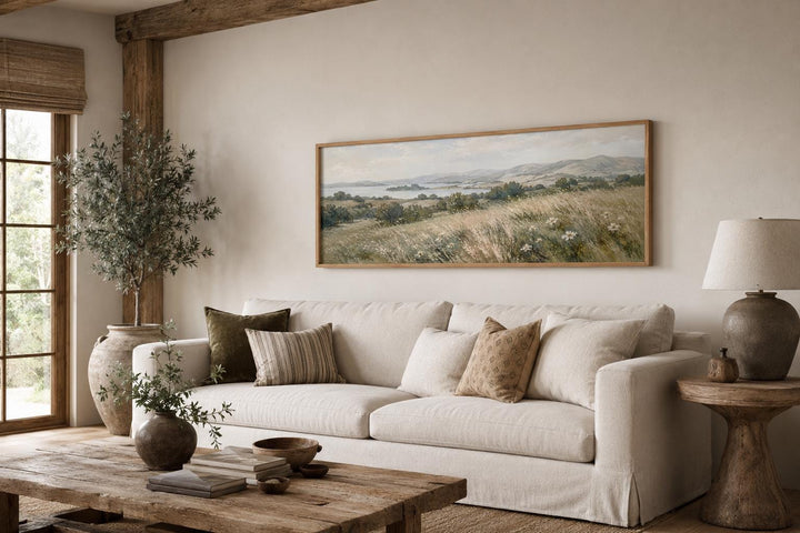 Long horizontal canvas of a farmhouse grass field landscape in a neutral living room.