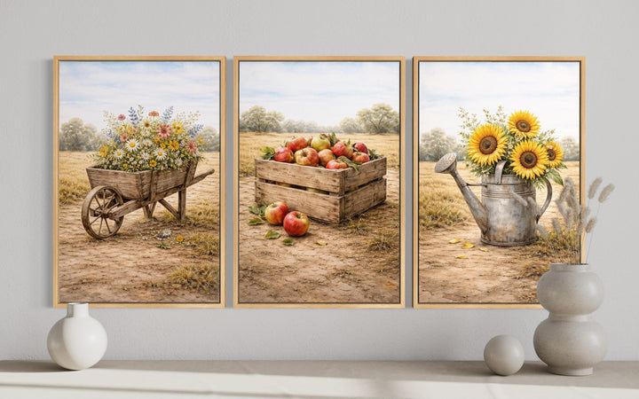 Set of three rustic farmhouse canvas prints featuring a wheelbarrow, apple crate, and sunflowers.