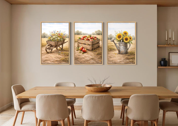 Set of three rustic farmhouse canvas prints featuring a wheelbarrow, apples, and sunflowers.