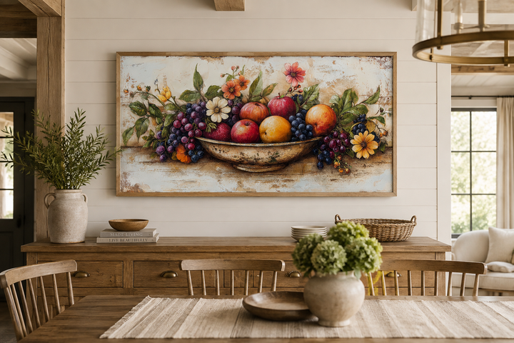 Rustic fruit bowl painting on a wood canvas print, framed and hanging in a farmhouse dining room.