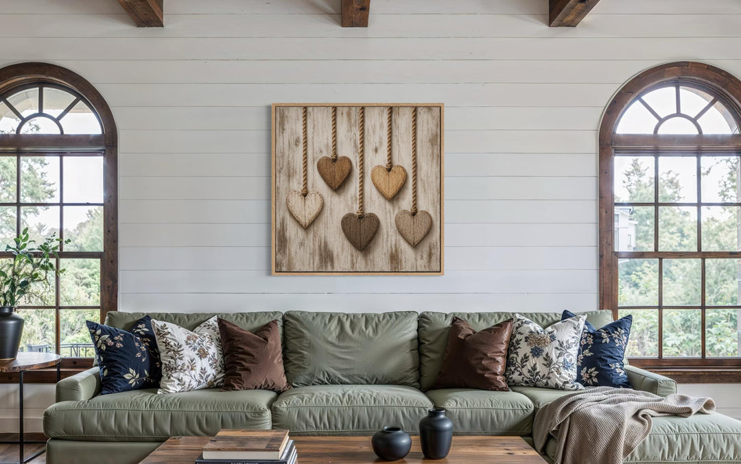 Rustic wall art featuring five wooden hearts on twine against a whitewashed wood background.