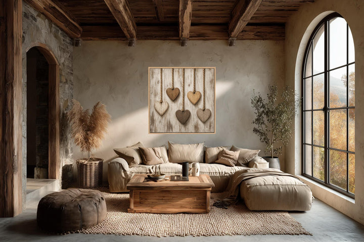 Rustic heart canvas art with five wooden hearts on whitewashed wood in a farmhouse living room.