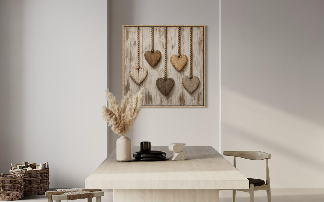 Rustic heart canvas wall art featuring five wooden hearts hanging on a whitewashed wood background.