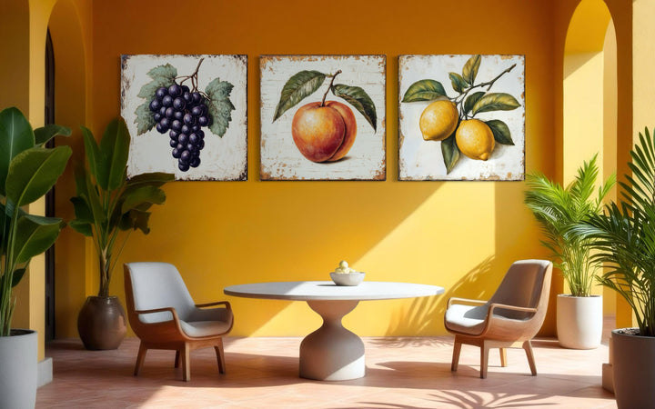 Vintage fruit canvas triptych featuring grapes, a peach, and lemons on a yellow wall.