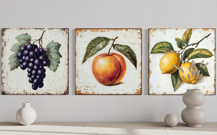 Vintage fruit canvas triptych featuring grapes, a peach, and lemons in a farmhouse kitchen style.
