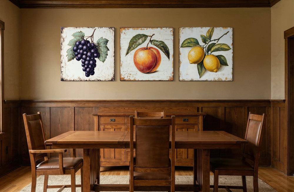 Triptych of vintage fruit canvas prints featuring grapes, a peach, and lemons in a dining room.