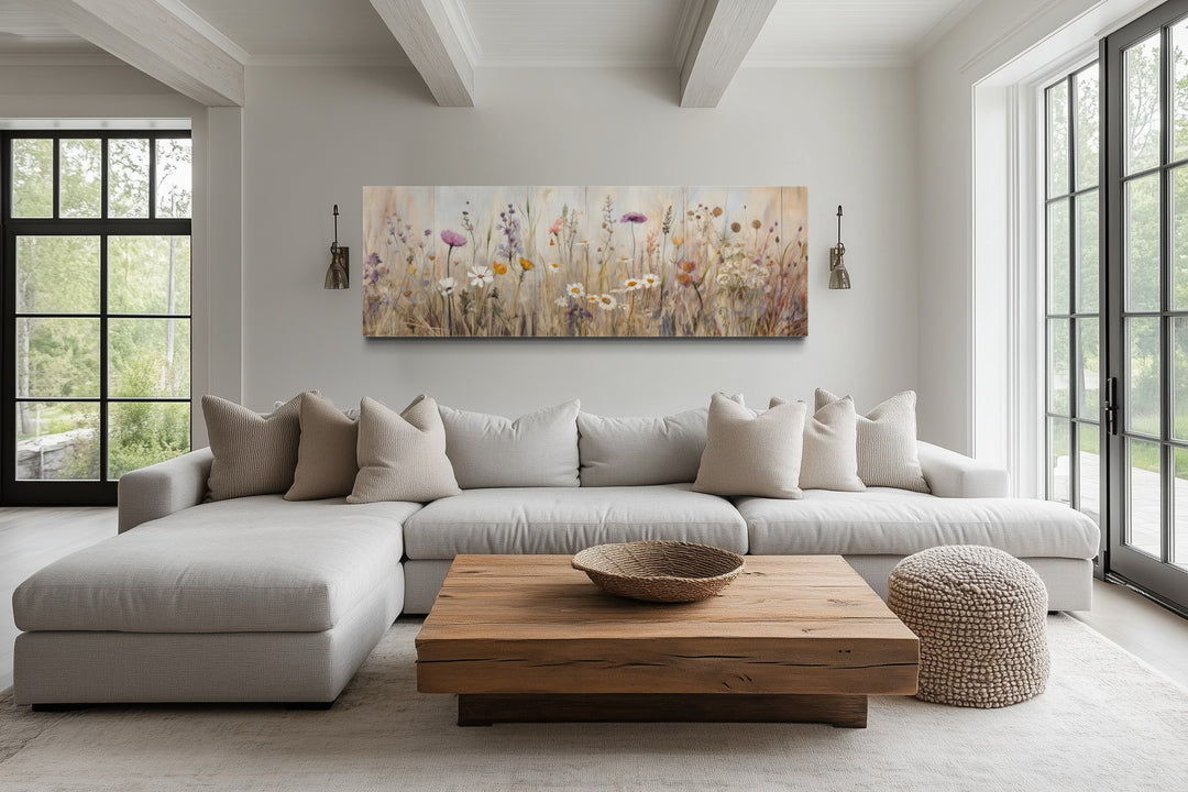 Neutral wildflower field horizontal framed canvas wall art above a sofa in a farmhouse living room.