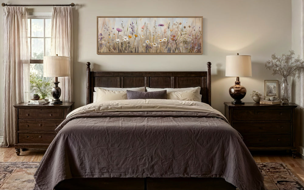 Horizontal framed canvas wall art featuring a neutral wildflower field above a dark wood bed.