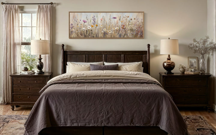 Horizontal framed canvas wall art featuring a neutral wildflower field above a dark wood bed.