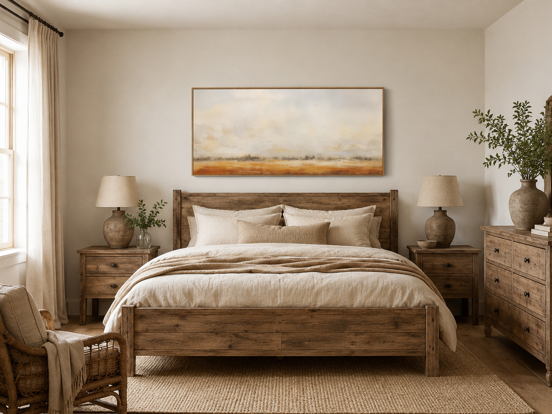 Minimalist farm field canvas painting in neutral tones hanging above a rustic wooden bed.