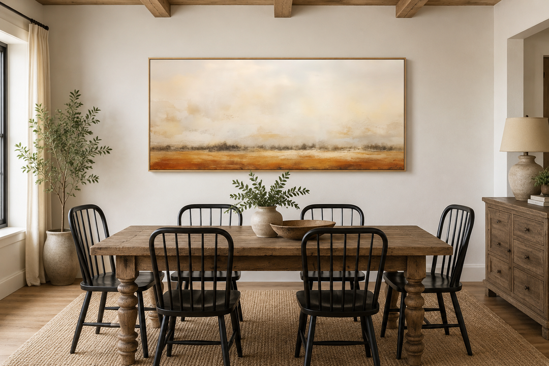 Minimalist farmhouse canvas art featuring a neutral rustic farm field painting above a dining table.