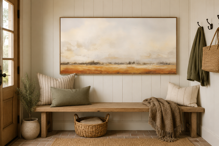 Minimalist farm field canvas painting in neutral tones hanging above a rustic wooden bench.