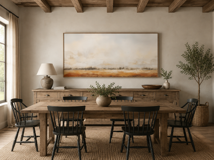 Minimalist farm field canvas art in neutral tones hanging above a rustic wooden sideboard.