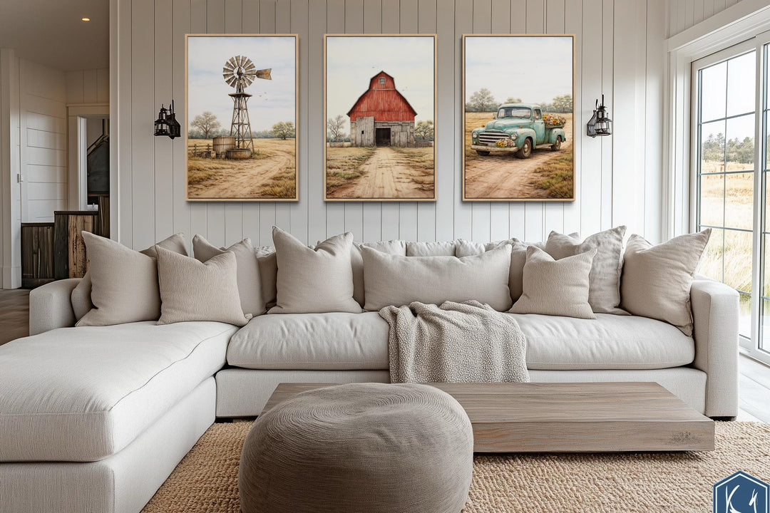 Set of 3 farmhouse canvas prints featuring a red barn, windmill, and vintage truck over a sofa.