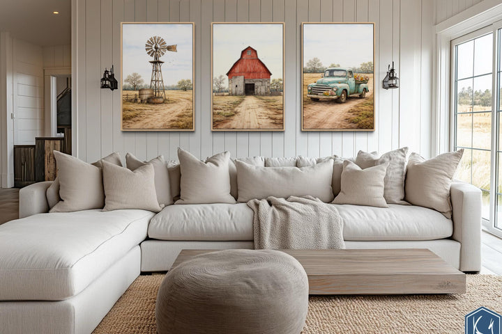 Set of 3 farmhouse canvas prints featuring a red barn, windmill, and vintage truck over a sofa.