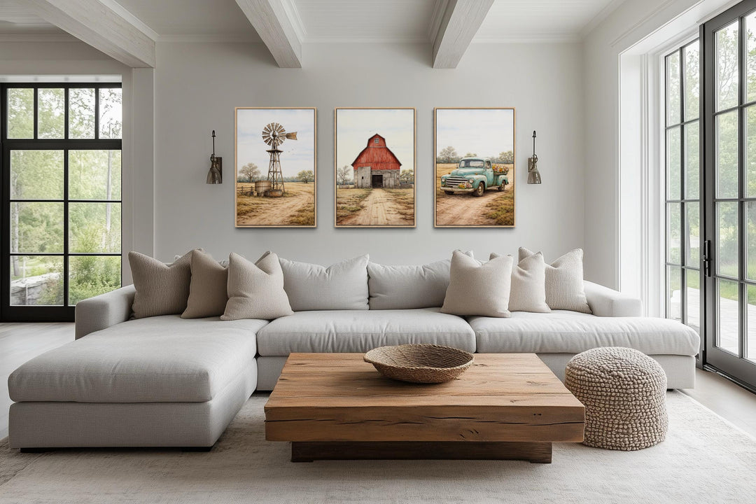 Set of 3 farmhouse canvas prints featuring a red barn, windmill, and vintage truck over a sofa.