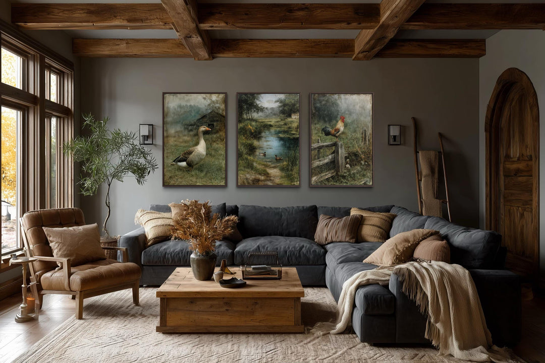 Three framed farmhouse paintings of a goose, ducks, and a rooster in a rustic living room.