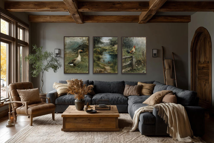 Three framed farmhouse paintings of a goose, ducks, and a rooster in a rustic living room.