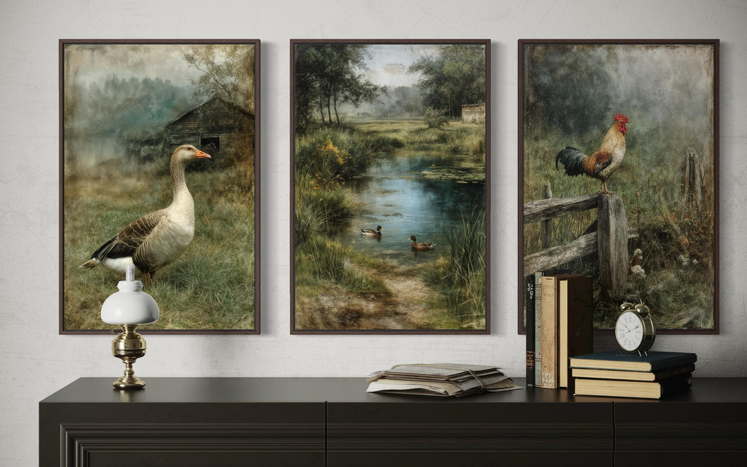 Three framed farmhouse paintings of a goose, ducks in a pond, and a rooster on a fence.